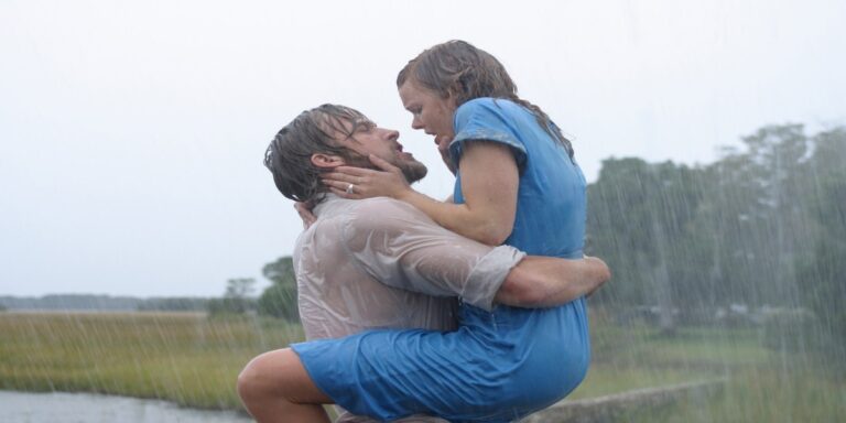 Lah holding Allie on chest in rain